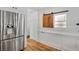 Close up of Pantry with stainless steel refrigerator and custom wood cabinets at 2705 Osborne Ne Rd, Brookhaven, GA 30319
