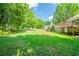 Large backyard with a wood deck offers great space for relaxing and entertainment at 6082 Raintree Bnd, Lithonia, GA 30058