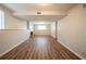 Spacious finished basement featuring hardwood floors, neutral paint, and a brick fireplace at 6082 Raintree Bnd, Lithonia, GA 30058