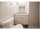 Neutral bathroom with a granite countertop, single sink vanity and standard toilet at 6082 Raintree Bnd, Lithonia, GA 30058