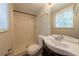 Bright bathroom featuring a walk-in shower, neutral walls, and a vanity with ample countertop space at 6082 Raintree Bnd, Lithonia, GA 30058