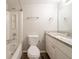Well-lit bathroom features a single sink vanity with granite counters, tub shower and toilet at 6082 Raintree Bnd, Lithonia, GA 30058