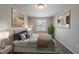Inviting bedroom featuring a plush bed, neutral tones, natural lighting and stylish decor at 6082 Raintree Bnd, Lithonia, GA 30058