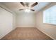 Cozy bedroom with neutral carpet, ceiling fan, and closet at 6082 Raintree Bnd, Lithonia, GA 30058