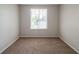 Bright bedroom featuring plush carpeting, neutral walls, and a bright window at 6082 Raintree Bnd, Lithonia, GA 30058