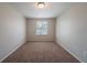 Cozy bedroom featuring plush carpeting, neutral walls, and a bright window at 6082 Raintree Bnd, Lithonia, GA 30058