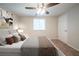 Relaxing bedroom with a plush bed, soft carpet, ceiling fan and natural light from the window at 6082 Raintree Bnd, Lithonia, GA 30058