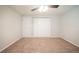 Neutral bedroom featuring carpeted floors and a ceiling fan for added comfort at 6082 Raintree Bnd, Lithonia, GA 30058