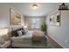 Inviting bedroom featuring a plush bed, neutral tones, natural lighting and stylish decor at 6082 Raintree Bnd, Lithonia, GA 30058