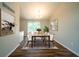 Stylish dining room featuring a long table with seating for eight and plenty of natural light at 6082 Raintree Bnd, Lithonia, GA 30058