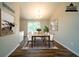 Stylish dining room featuring a long table with seating for eight and plenty of natural light at 6082 Raintree Bnd, Lithonia, GA 30058