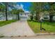 Inviting split-level home featuring a well-manicured lawn and an attached two-car garage at 6082 Raintree Bnd, Lithonia, GA 30058