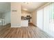 Inviting open-concept living area with hardwood floors, kitchen, and access to an outdoor deck at 6082 Raintree Bnd, Lithonia, GA 30058