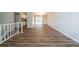 Spacious living room with wood floors leading to an updated kitchen at 6082 Raintree Bnd, Lithonia, GA 30058