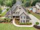 Aerial view of a stunning home with a pool, landscaping, and a long driveway at 6263 Fernstone Nw Trl, Acworth, GA 30101
