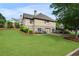 Home with a lush green lawn, with a walkout basement, stone accents, and a well-manicured landscape at 6263 Fernstone Nw Trl, Acworth, GA 30101