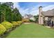 Manicured backyard with a stone-walled garden and lush green lawn at 6263 Fernstone Nw Trl, Acworth, GA 30101