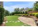 Spacious backyard boasting a stone patio, lush lawn, and neatly trimmed hedges at 6263 Fernstone Nw Trl, Acworth, GA 30101