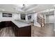 Open basement layout showcasing a granite-topped bar, wood floors, and easy access to other entertainment areas at 6263 Fernstone Nw Trl, Acworth, GA 30101