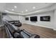 Finished basement with a large leather couch and entertainment center at 6263 Fernstone Nw Trl, Acworth, GA 30101