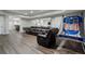 Finished basement with a large leather couch and recreational basketball game, great for entertaining at 6263 Fernstone Nw Trl, Acworth, GA 30101