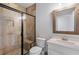 Bathroom featuring a glass enclosed shower with bench and a vanity with white countertop at 6263 Fernstone Nw Trl, Acworth, GA 30101