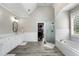 Bright bathroom with a walk-in closet, shower, soaking tub, and dual sink vanity at 6263 Fernstone Nw Trl, Acworth, GA 30101