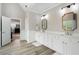 Bright bathroom with a walk-in closet, white cabinets, and dual sink vanity at 6263 Fernstone Nw Trl, Acworth, GA 30101
