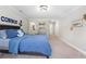 Spacious bedroom with a nautical theme, plush bedding, and carpeted floors at 6263 Fernstone Nw Trl, Acworth, GA 30101