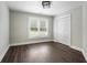 Bright bedroom with a window featuring shutters and a closet with standard, hinged doors at 6263 Fernstone Nw Trl, Acworth, GA 30101
