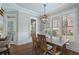 Dining room features shuttered windows, hardwood floors, modern lighting, and decorative trim at 6263 Fernstone Nw Trl, Acworth, GA 30101