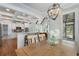 Bright dining area with hardwood floors, white trim, chandelier and view of open kitchen at 6263 Fernstone Nw Trl, Acworth, GA 30101