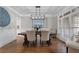 Elegant dining room with hardwood floors, decorative lighting, and stylish neutral furniture at 6263 Fernstone Nw Trl, Acworth, GA 30101