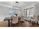 Elegant dining room featuring wood floors, modern lighting, and comfortable neutral seating at 6263 Fernstone Nw Trl, Acworth, GA 30101