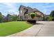 Beautiful home featuring lush green lawn, complemented by a well-maintained landscape at 6263 Fernstone Nw Trl, Acworth, GA 30101
