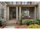Charming front porch with stone columns and welcome decor at 6263 Fernstone Nw Trl, Acworth, GA 30101