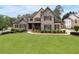 Stunning stone and shake home featuring a manicured lawn and lush landscaping at 6263 Fernstone Nw Trl, Acworth, GA 30101