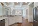 Modern kitchen with stainless steel appliances, white cabinetry, and dining area at 6263 Fernstone Nw Trl, Acworth, GA 30101