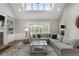 Spacious living room with large windows, fireplace, built-in shelving, and a comfortable sectional sofa at 6263 Fernstone Nw Trl, Acworth, GA 30101
