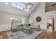 Bright living room with high ceilings, large windows, and a comfortable sectional sofa at 6263 Fernstone Nw Trl, Acworth, GA 30101