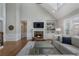 Bright living room featuring a cozy fireplace, hardwood floors, and large windows at 6263 Fernstone Nw Trl, Acworth, GA 30101