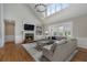 Inviting living room featuring a cozy fireplace, hardwood floors, and large windows at 6263 Fernstone Nw Trl, Acworth, GA 30101