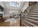Cozy living room with fireplace, staircase, and plenty of natural light at 6263 Fernstone Nw Trl, Acworth, GA 30101