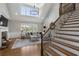 Living room with hardwood stairs, fireplace, large windows and a comfortable sectional sofa at 6263 Fernstone Nw Trl, Acworth, GA 30101
