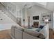 Spacious living room with fireplace, hardwood floors, large windows, and staircase at 6263 Fernstone Nw Trl, Acworth, GA 30101
