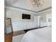 Spacious main bedroom with a modern chandelier, large TV, and ensuite access at 6263 Fernstone Nw Trl, Acworth, GA 30101
