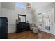 Cozy sitting area within the main bedroom featuring an arched window and comfortable furniture at 6263 Fernstone Nw Trl, Acworth, GA 30101