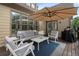 Inviting outdoor patio with comfortable seating, umbrella, and well-maintained deck at 6263 Fernstone Nw Trl, Acworth, GA 30101