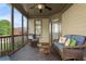 Relaxing screened-in porch with comfortable seating at 6263 Fernstone Nw Trl, Acworth, GA 30101