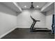 Workout room with a treadmill, rubber flooring, and a ceiling fan at 6263 Fernstone Nw Trl, Acworth, GA 30101